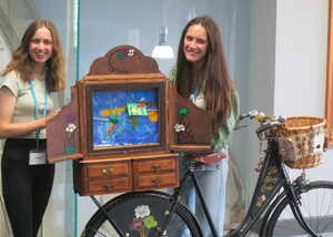 Interior of a modern space with a decorative floor and green accents.