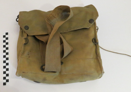 khaki coloured canvas bag with dark metal rivets, shows signs of age and use