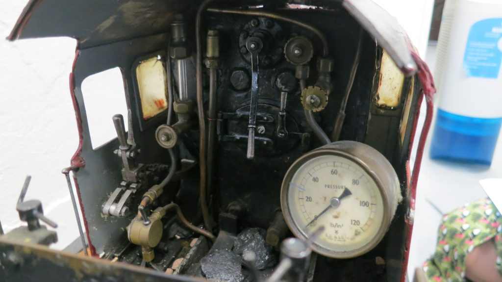 inside the drivers cabin of the locomotive, there are many levers and cogs