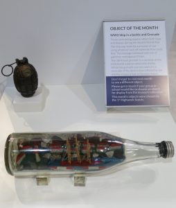 WW2 Ship in a bottle and Grenade. These contrasting objects reflect both hope and despair during the Second World War. The ship was made by a prisoner of war